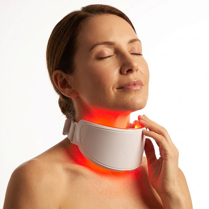 Woman using a neck massager with red light on a white background
